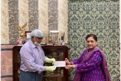 Smt Alka Bangur giving a cheque of ₹ 1,90,000.00 to Shri M.C.Kothari of  Howrah Lions Hospital Uluberia to buy a biometric machine known as scan max used for eye check ups essential for eye operation on 27.02.2021